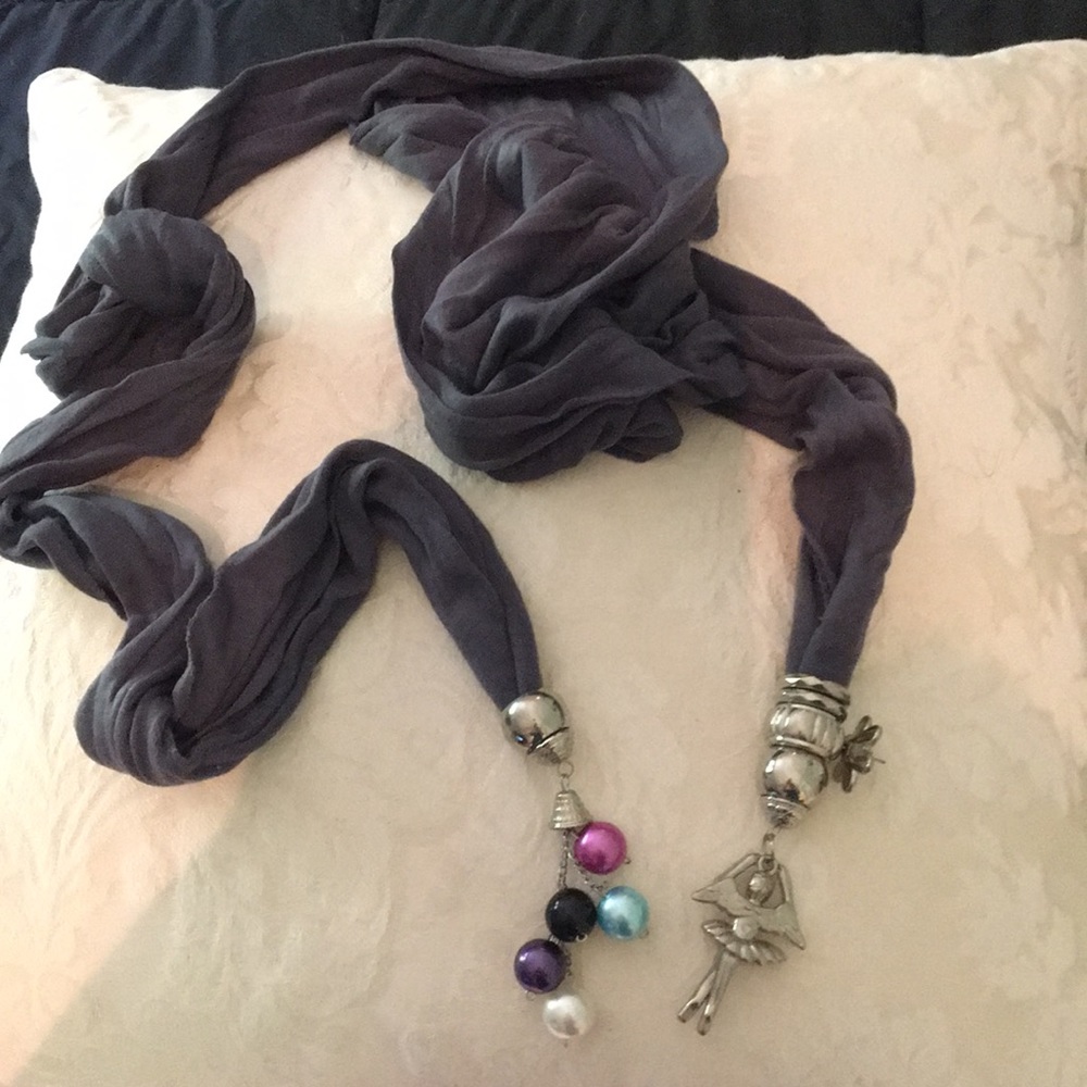Versatile scarf with multiple charms.